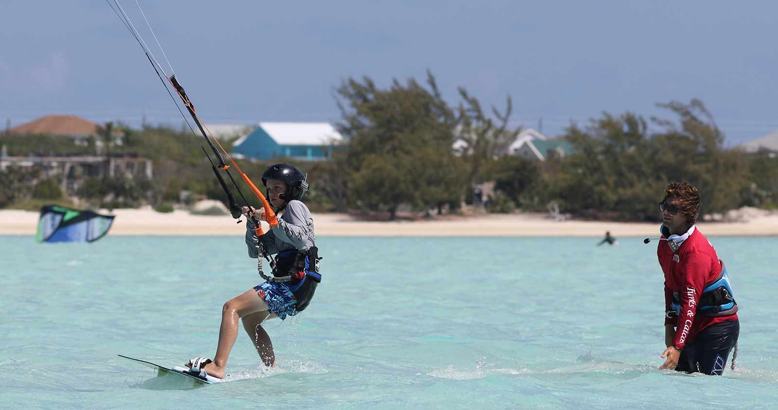 kite provo teaches kiteboarding to a kid with radio communication system