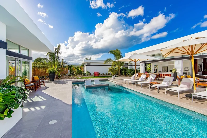 Private pool with sun loungers beside a White Villas villa
