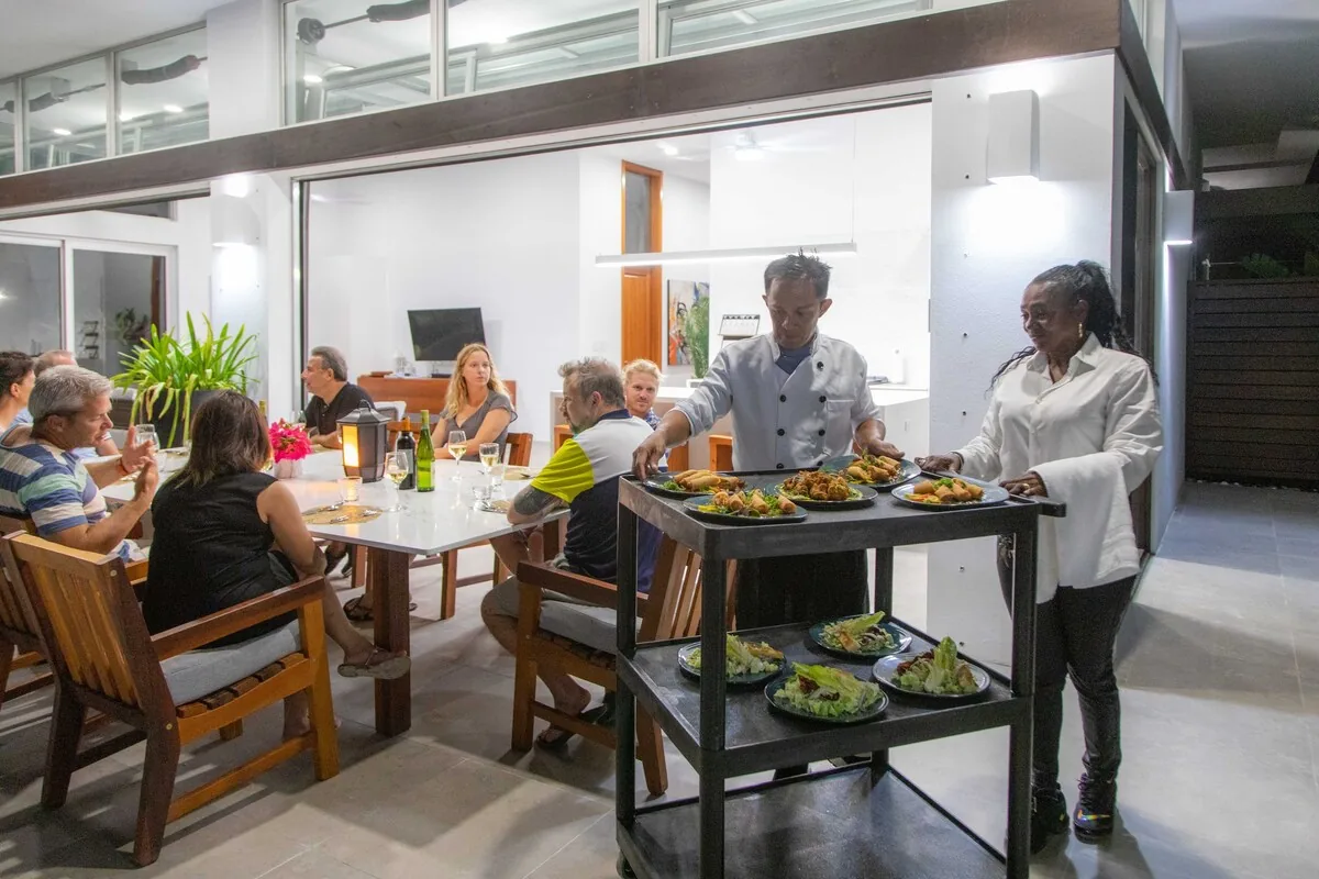 White Villas private chef serving guests dining on the villa terrace
