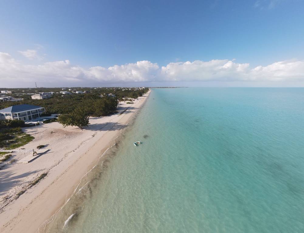 Long Bay Beach, Providenciales, shallow turquoise water and kiteboarders in the distance