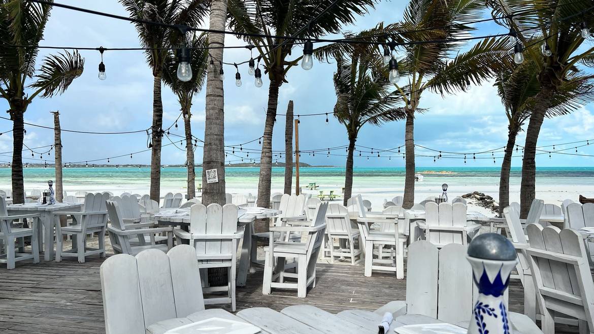 Beachfront deck under the palms at Bugaloos in Five Cays