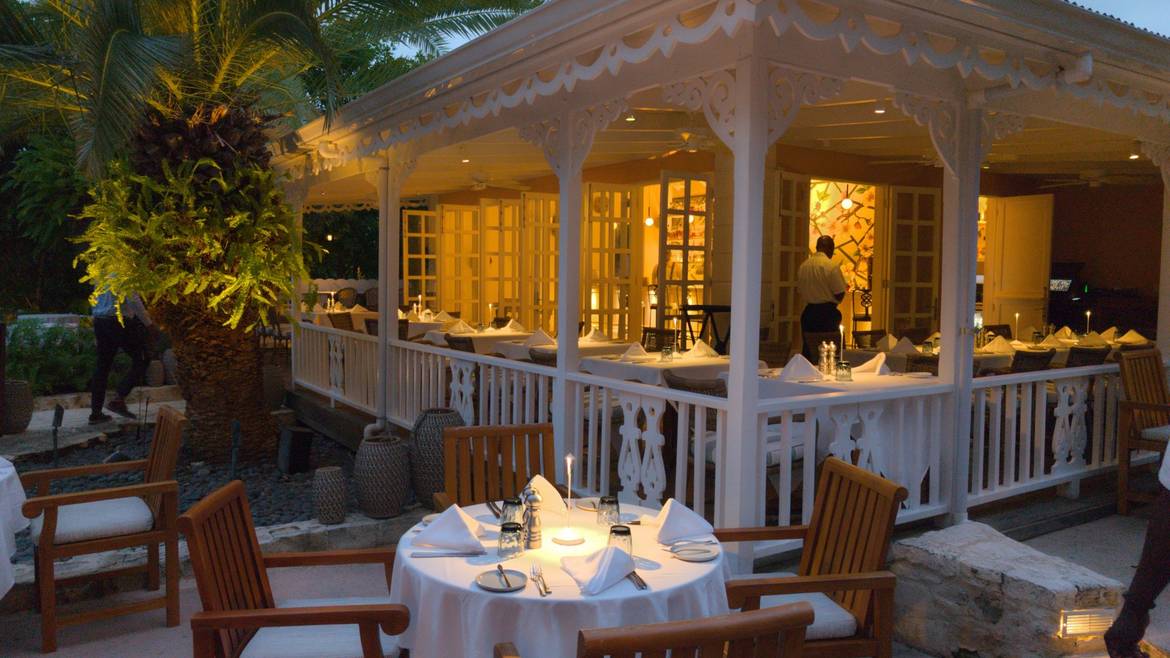 Grace's Cottage restaurant terrace lit for dinner in Grace Bay