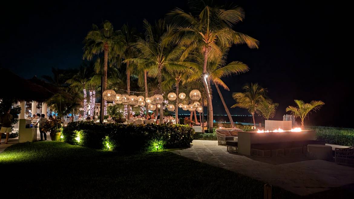 Infiniti Restaurant and Raw Bar lit up at night at Grace Bay Club