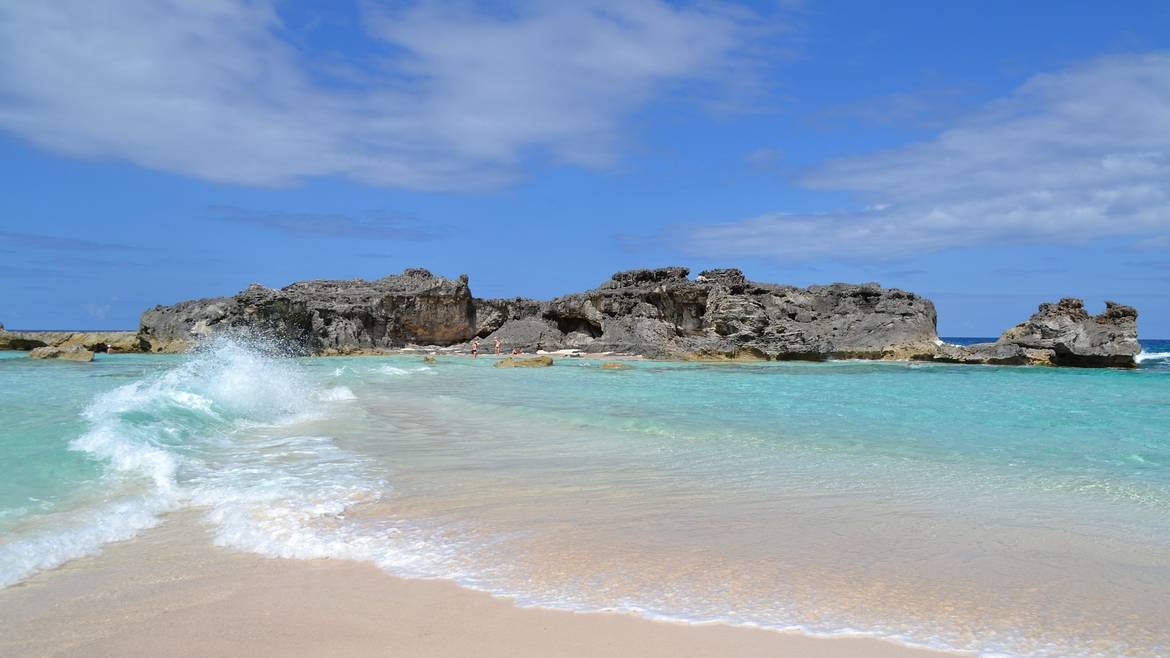Waves on the beach at Mudjin Harbour with limestone rocks offshore, Middle Caicos