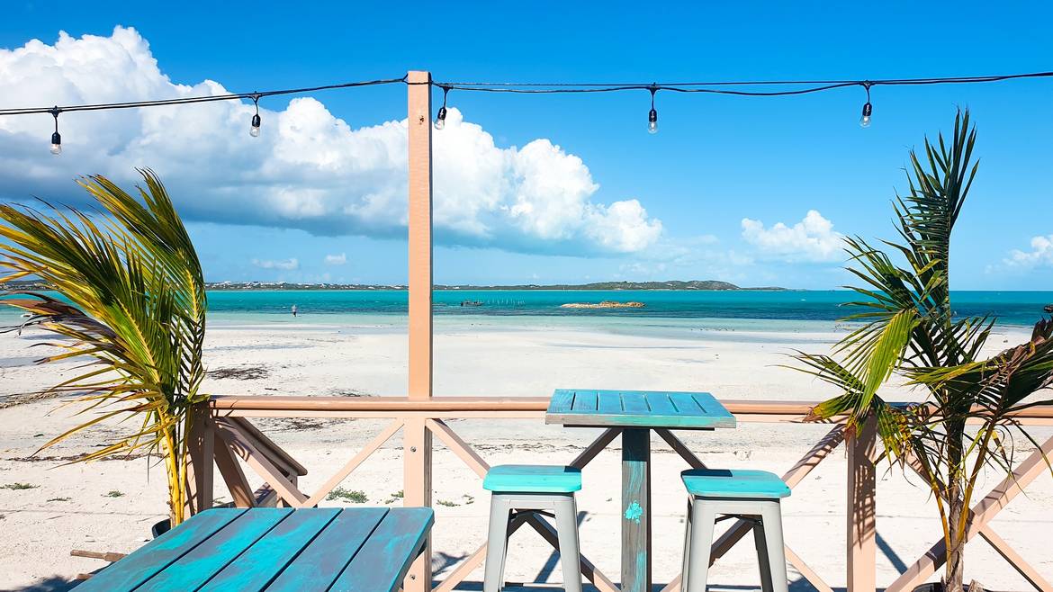 A beachfront table looking out to Five Cays Beach at Omar's Beach Hut, Providenciales