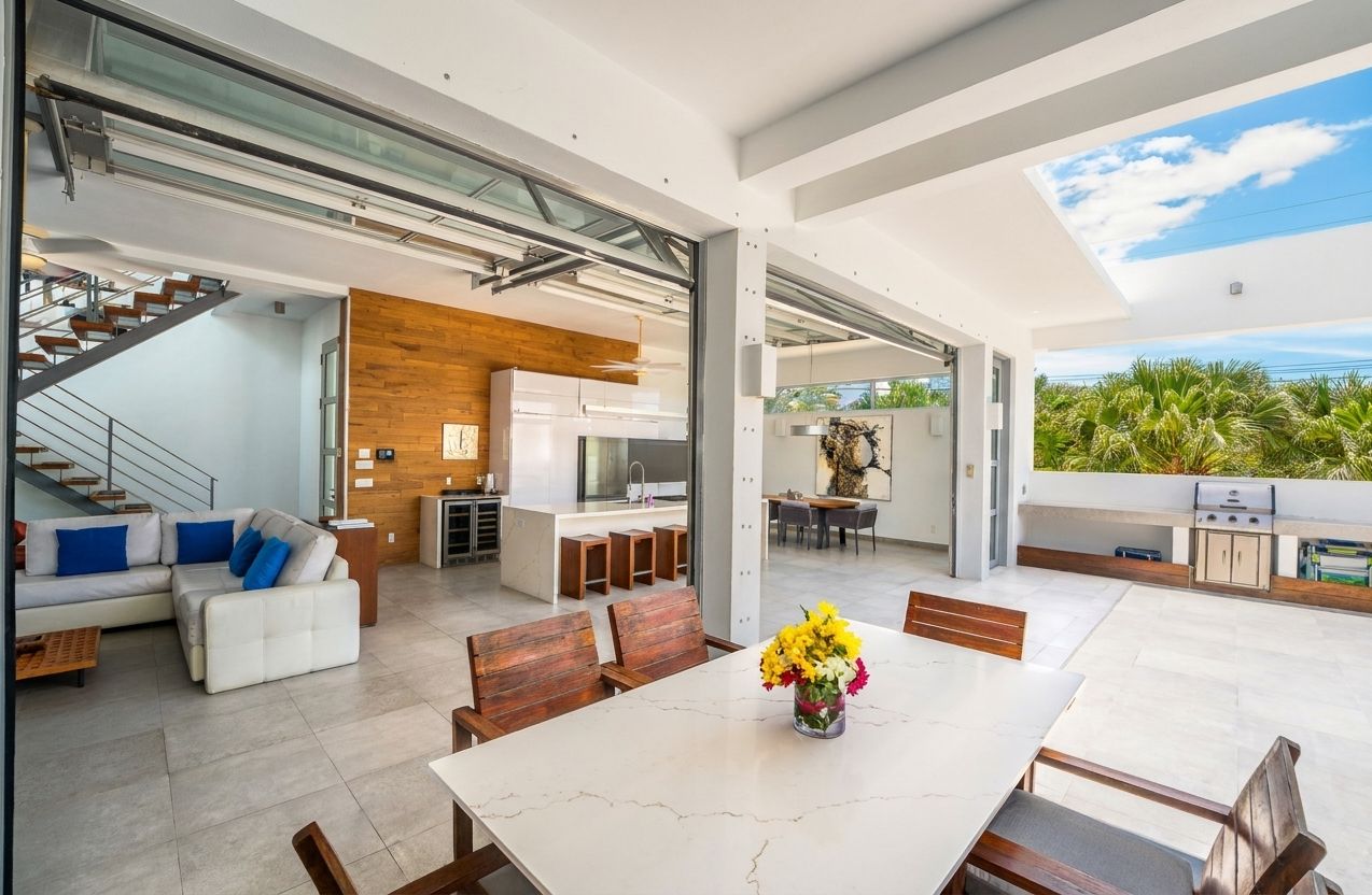 Villa 1 at White Villas: dining table and open kitchen facing the pool terrace