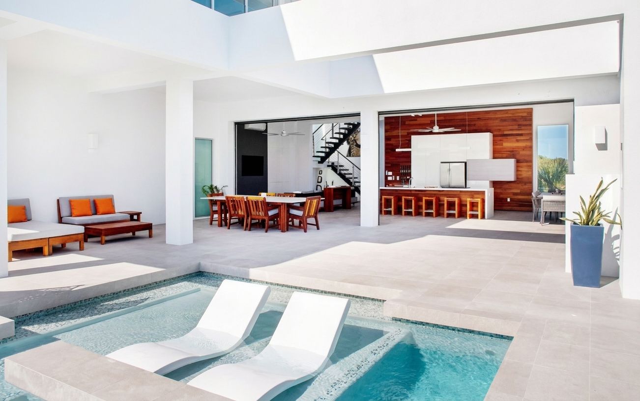Villa 6 at White Villas: outdoor dining table and pool with in-water loungers