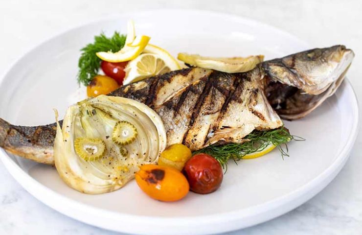 Grilled Whole Mediterranean Sea Bass, Braised Fennel, Blistered Heirloom Tomatoes, Garlic & Lemon Butter